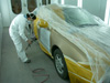 Here is one of our professional painters puting a fresh coat of paint on a repaired car door. Special care is taken to make sure that the paint is perfectly done.